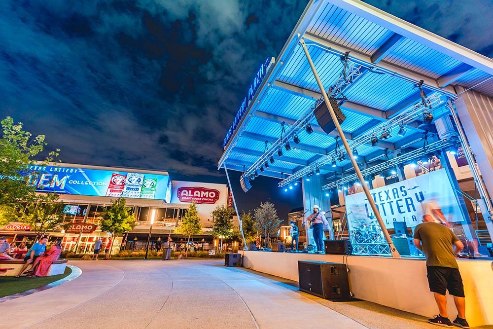 Texas Lottery® Plaza Stage lit up with blue lights